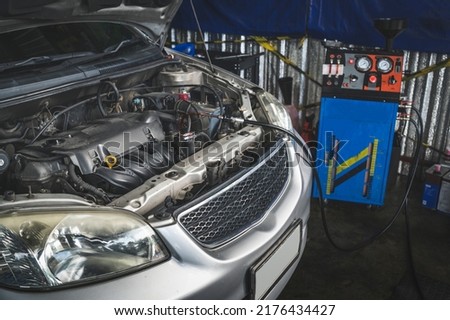 A Transmission flush service is a process in which the fluid in an automatic transmission is flushed out of the transmission by flushing machine and replaced with new automatic transmission fluid. Royalty-Free Stock Photo #2176434427