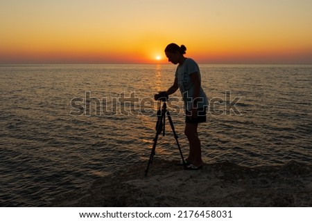 Female photographer taking pictures at sunset. Kerpe, Kocaeli, Turkey