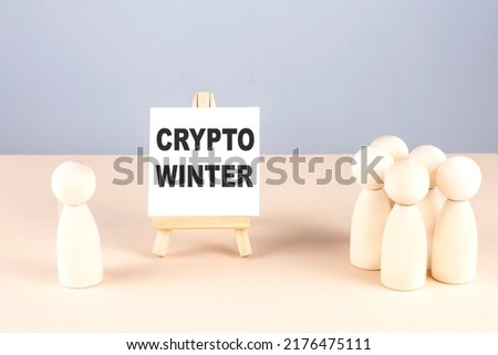 CRYPTO WINTER text on a easel with wooden figure, meeting concept