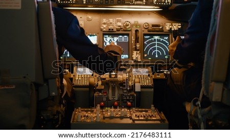 Airplane captain throttling engine to takeoff and fly plane, using power handle and control panel command. Pushing lever to travel and use aerial navigation, flying aircraft. Close up. Royalty-Free Stock Photo #2176483111