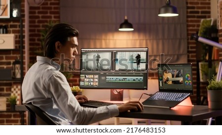 Asian videographer editing video montage with visual effects, using color gradient software to design movie footage for film production. Creative multimedia edit for professional content.