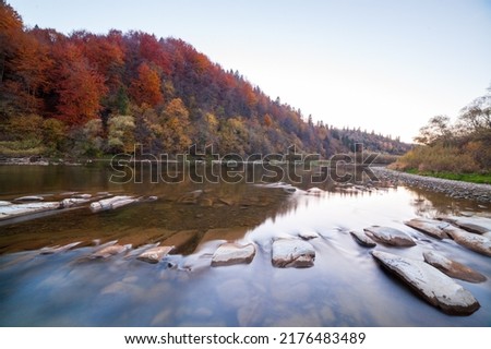 View of the waterfall in autumn. Waterfall in autumn colors. Mountain river in the autumn landscape. Ukraine, river Stryj. High quality photo