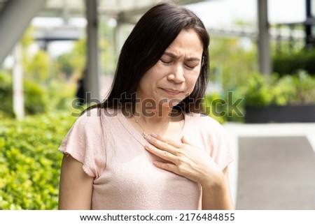 Middle-aged woman having gerd acid reflux, heartburn inflammation Royalty-Free Stock Photo #2176484855