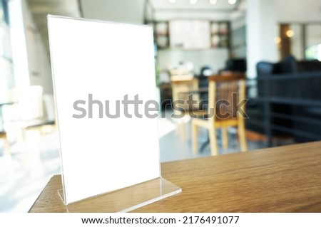 Wenu frame standing on wood table in  Bar restaurant cafe. Space for text marketing promotion. 