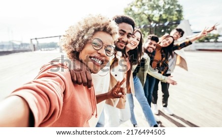 Multiracial best friends taking selfie on city street - Different young people having fun hanging outside on a sunny day - Happy students laughing together in college campus