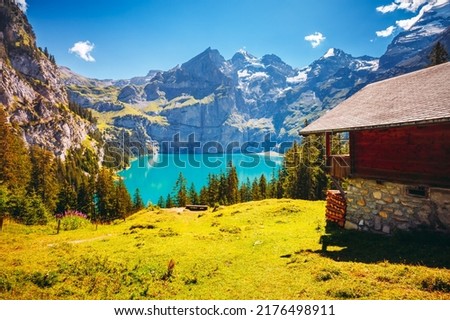 Perfect summer view of the lake Oeschinensee in sunny day. Location Swiss alps, Switzerland, Kandersteg district, Europe. Vibrant photo wallpaper. Image of exotic place. Discover the beauty of earth. Royalty-Free Stock Photo #2176498911