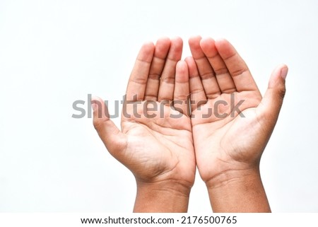 Muslim child man lift two hand for praying ,isolated on white background.concept for Ramadan, Eid al Fitr, eid ad-ha, meditation, islamic praying Royalty-Free Stock Photo #2176500765