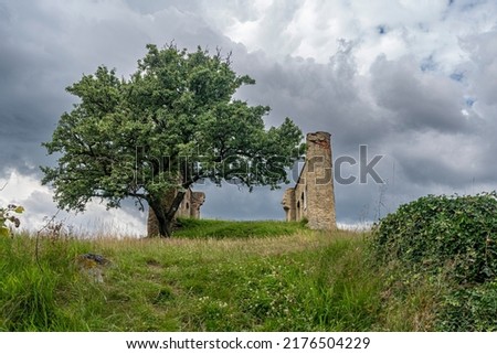 the ruin of a summer house from the 18th century on the Kamýk rock near Rokycan with a wonderful view of the surrounding wooded hilly terrain under cloudy skies