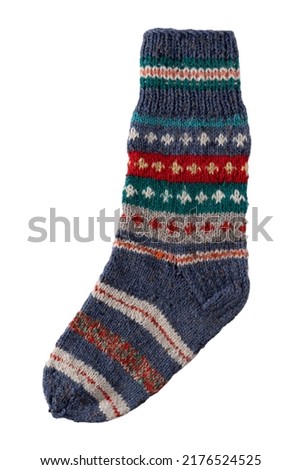 Knitting socks from woolen threads isolated on white background. Handmade cozy homemade warm winter colorful striped knitted socks.