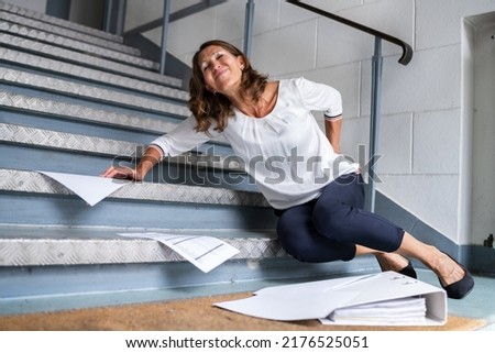 Fall And Fall Injury Accident At Workplace. Woman Fell Down Stairs Royalty-Free Stock Photo #2176525051