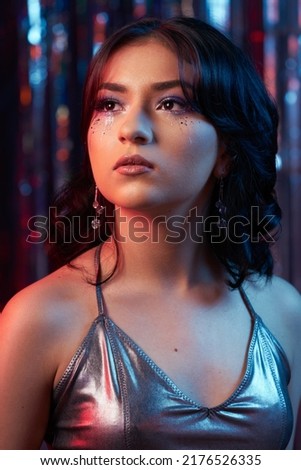 portrait of a teenage girl on a prom dance floor, party make-up, silver rainbow background