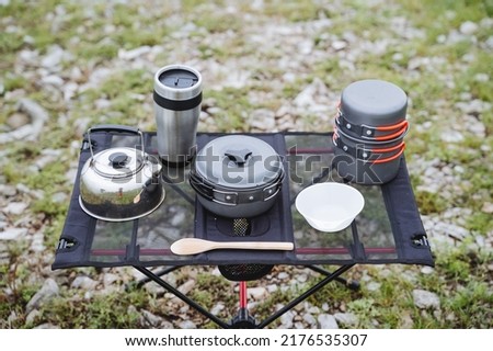 Camping utensils, compact camping gear, outdoor cooking equipment, camping table, small kettle, soup pan. High quality photo
