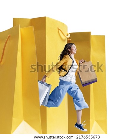 Cheerful young woman running and holding shopping bags, sales and fashion concept, isolated on white background Royalty-Free Stock Photo #2176535673