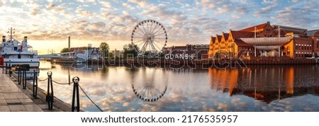 Gdansk, Poland. Panoramic view of ferris wheel and Gdansk sign at Motlawa river during sunrise. Eastern Europe travel destination at Baltic sea Royalty-Free Stock Photo #2176535957