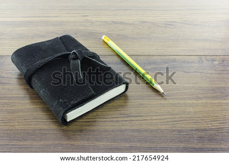 Black Leather notebooks on wood