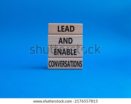 Lead and enable conversations symbol. Concept words Lead and enable conversations on wooden blocks. Beautiful blue background. Business and Lead and enable conversations concept. Copy space.