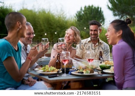Happy middle-aged men and women toasting healthy food at farm house picnic - Life style concept with cheerful friends having fun together on afternoon relax time Royalty-Free Stock Photo #2176583151