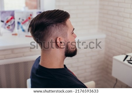 
Male head with stylish haircut on barbershop background
 Royalty-Free Stock Photo #2176593633