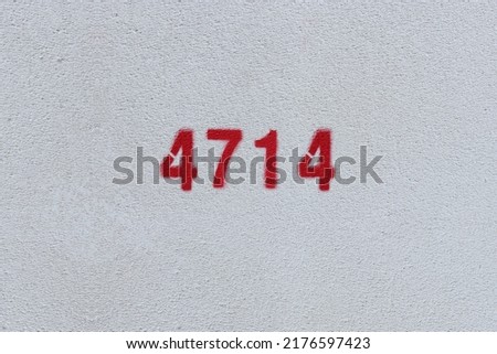 Red Number 4714 on the white wall. Spray paint.
