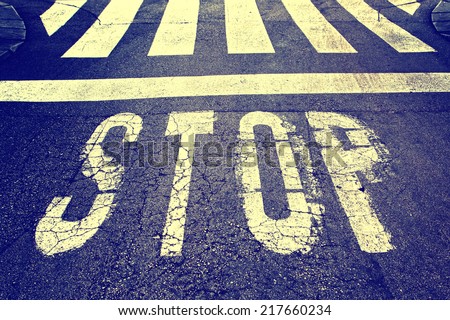 Vintage stop sign on city asphalt floor.