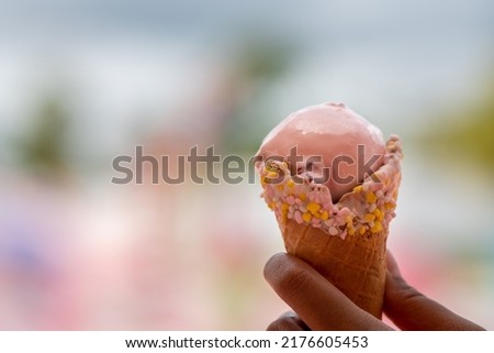 Bruntte girl holding Ice Cream at Sweet Candy Deserts Land on Fluffy Clouds, Woman with Icecream Cone fresh fressz cool and verry good tasty Home made ice cream on Summer day at Icecream land