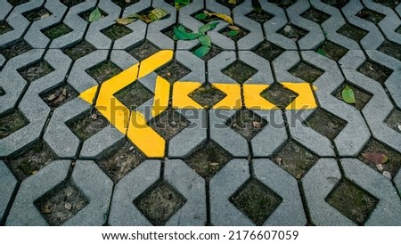 Yellow arrows on the parking lot floor