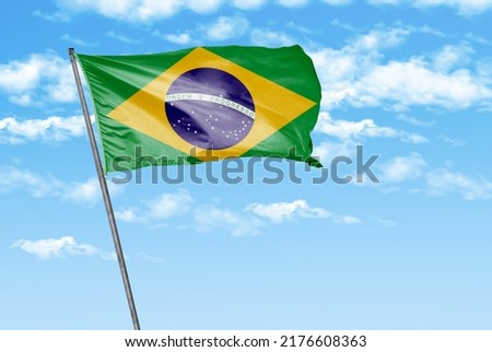 Brazil waving flag on a sky blue with cloud background. - image
