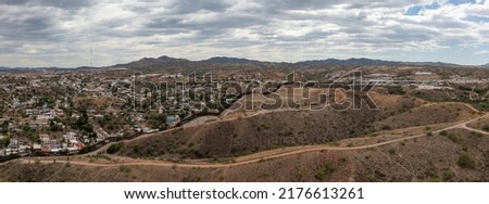 Aerial view of US Mexico Border fence in Nogales, Arizona. Drone panorama.  Royalty-Free Stock Photo #2176613261
