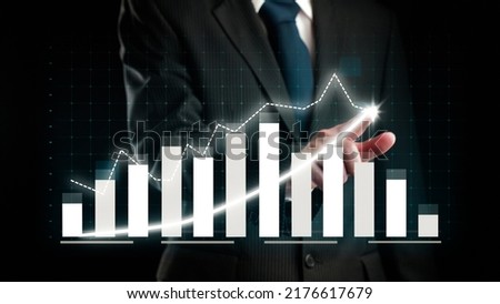 Businessman draw finance allusive graph chart showing business profit growth increasing to future target . Excellent financial status of corporate business rise up . Finance and money technology .