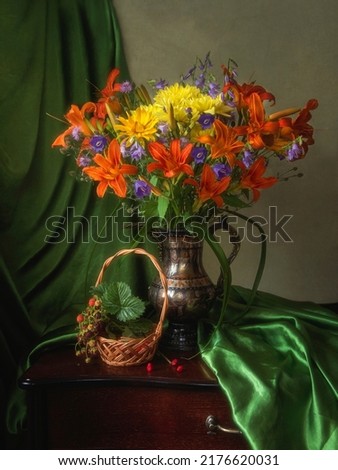 Still life with bouquet of  splendid garden flowers and strawberries