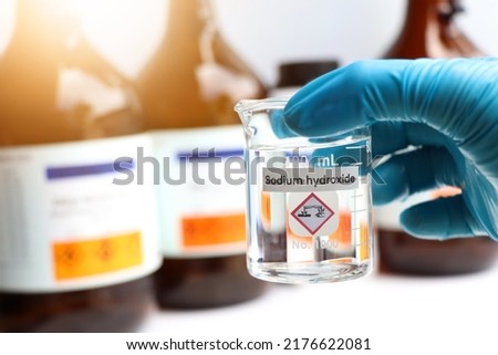 Sodium hydroxide in glass, chemical in the laboratory and industry Royalty-Free Stock Photo #2176622081