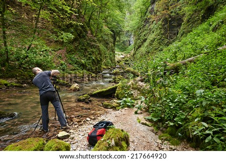 Professional nature photographer shooting landscapes in a canyon, from a tripod