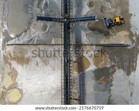 Aerial photo of excavator on industrial place. Industrial site top view. Shooting from the drone.