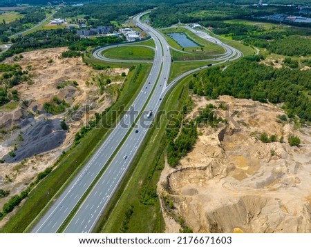 The motorway running through the former mining areas. Mining heaps, near Bytom, Poland.  Royalty-Free Stock Photo #2176671603