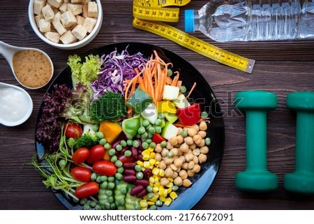 Diet and Healthy life loss weight exercise Concept. Fresh vegetable salad with Weight scale measure prevention for women diet slimming. Lifestyle Time and Healthy	