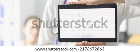 Doctor showing digital tablet screen with heart cardiogram result Royalty-Free Stock Photo #2176672863