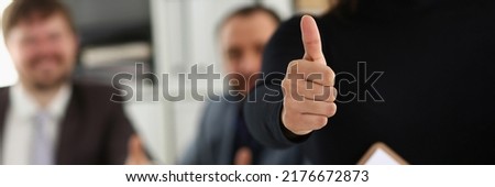 Group of young businesspeople happy to make good deal show thumbs up