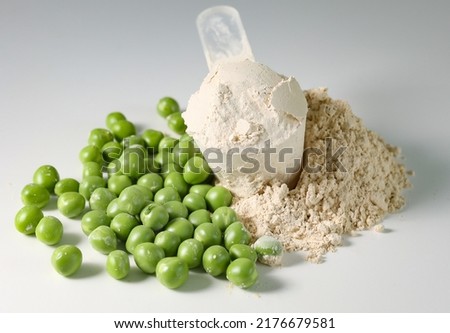 Plant base protein Pea Protein Powder in plastic scoop with fresh green Peas seeds on white Background, isolated copy space.  Royalty-Free Stock Photo #2176679581