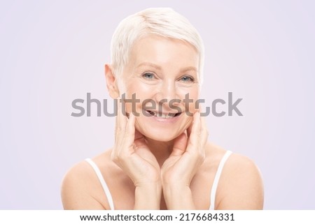 Beauty face portrait of cute and pretty senior woman with perfect fresh skin, isolated on pink background Royalty-Free Stock Photo #2176684331