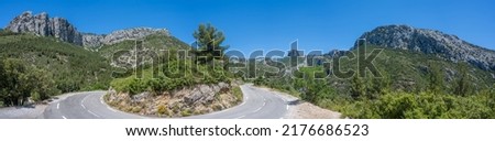 Curved mountain road and panorama view of the landscape around "vallon st pons" near Gemenos in the Bouches-du-Rhône department, Provence-Alpes-Côte d’Azur. "Pic de Bertagne" visible in background.