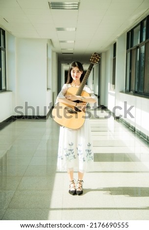 A girl with a guitar in her hand
