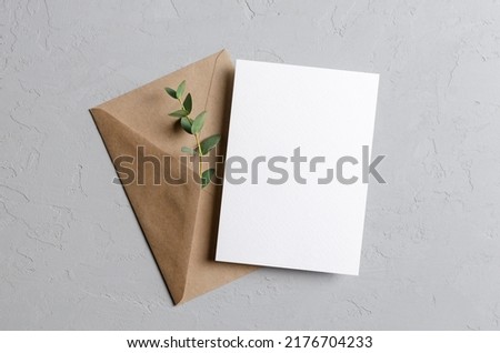 Invitation or save the date card mockup with envelope and fresh eucalyptus twig