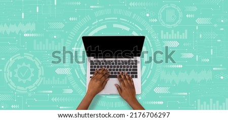 Millennial african american guy typing on laptop keyboard with empty screen on green background with abstract symbols, collage. Database, freelance, blog and internet service, technology and work
