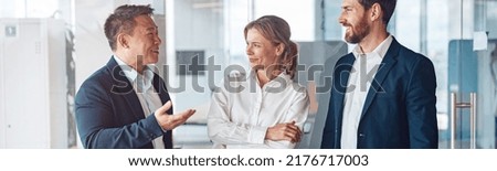 Young cheerful business people communicate in a meeting room. Teamwork concept