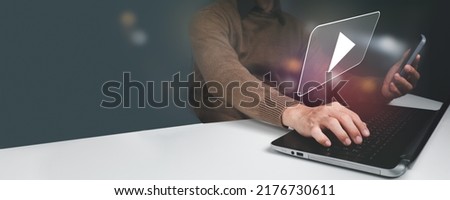 A man is streaming online, seeing movies on the internet, or attending a live performance, show, or instruction on his mobile phone. Online live streaming video marketing concept, Royalty-Free Stock Photo #2176730611