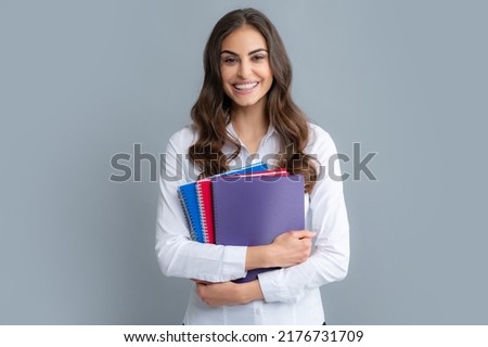 Happy smiling student or teacher. Student education in high school university college concept. Happy young girl holding note book. Smart looking girl student.