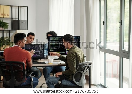 Software developers discussing programming code and planning how to create innovative software Royalty-Free Stock Photo #2176735953