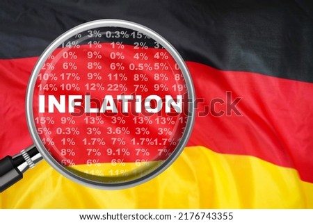 Magnifying glass focused on the word inflation on Germany flag background. Hike interest rate. Inflation income crisis. Inflation, tax, cash flow and another financial concept in Germany Royalty-Free Stock Photo #2176743355