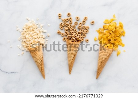 Waffle cones filled with various types of cereal. Royalty-Free Stock Photo #2176771029