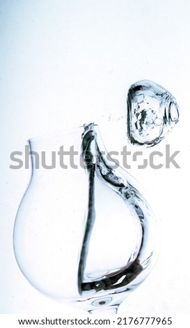 Bubbles of water and glass half filled with water beautiful shape of bubble from wine glass